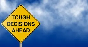 Road Sign That Says Tough Decisions Ahead