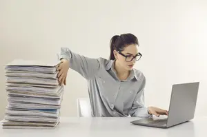Self-employed professional managing both digital and physical business records