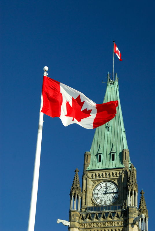 Canadian flage flying in front of Parliament Building in Ottawa symbolizing Canadian flage flying in front of Parliament Building in Ottawa symbolizing