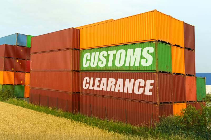 Multi-coloured stacked shipping containers waiting for customs clearance