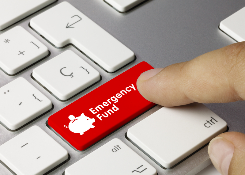 Finger pressing red emergency fund key on a keyboard