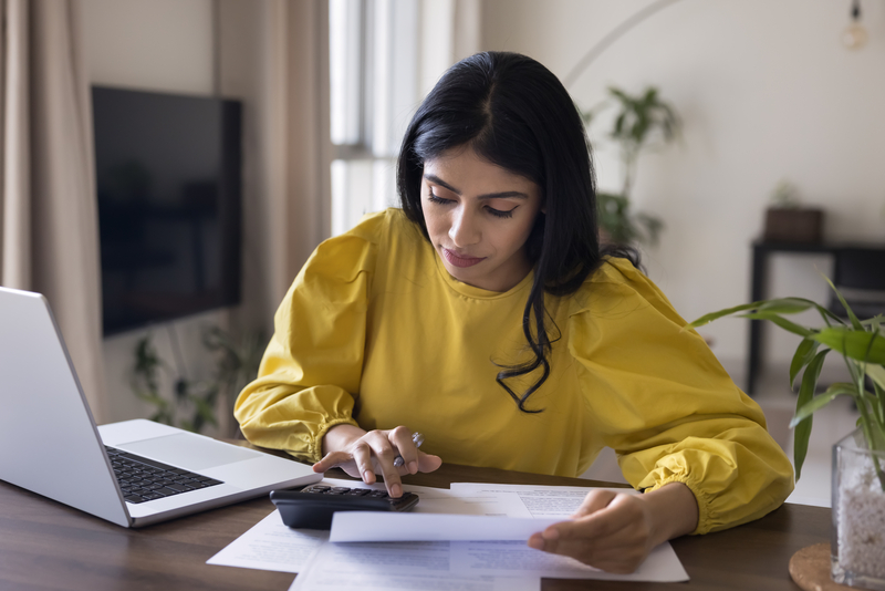 Home-based solopreneur at workspace-reviewing-profit-and-loss-statement