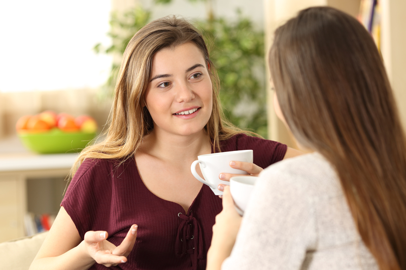 Friends having a relaxed conversation over coffee