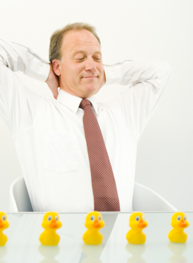 Satified businessman with all his ducks in a row