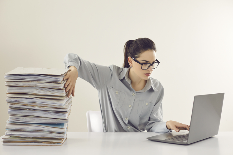Self-employed professional managing both digital and physical business records