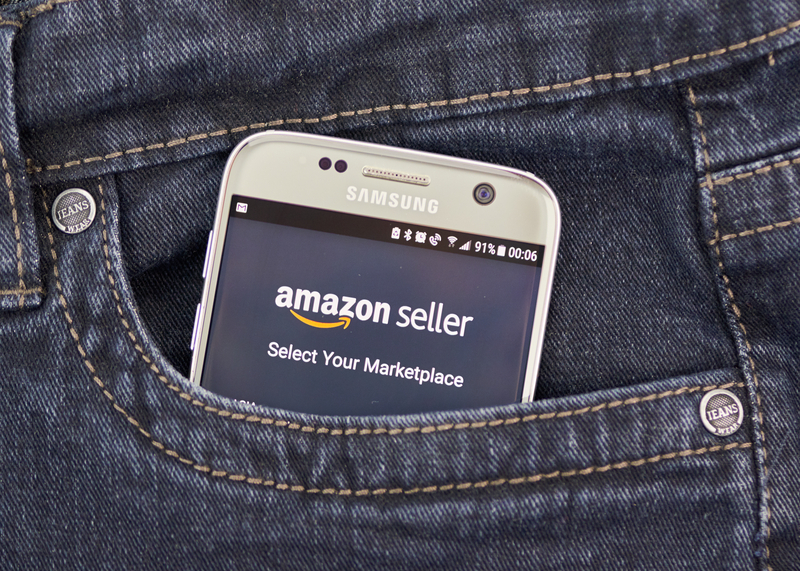 Seller checking Amazon marketplace app on smartphone