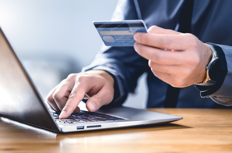 Businessman paying with a credit card on a laptop